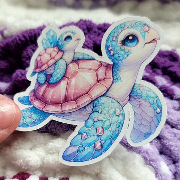 A whimsical illustration of a mother and baby turtle with gem-like shells, adorned with crystals, swimming together in vibrant turquoise and pink hues.