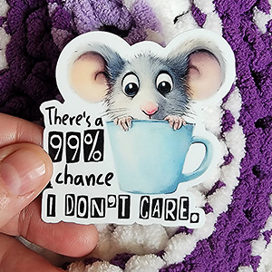 Adorable mouse named Cuppy peeking out of a blue cup with the caption "There's a 99% chance I don't care."