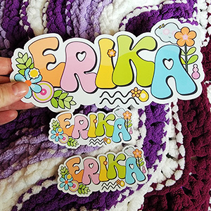 Colorful and playful custom name sticker with the name "ERIKA," featuring vibrant letters and decorative elements like flowers and leaves.