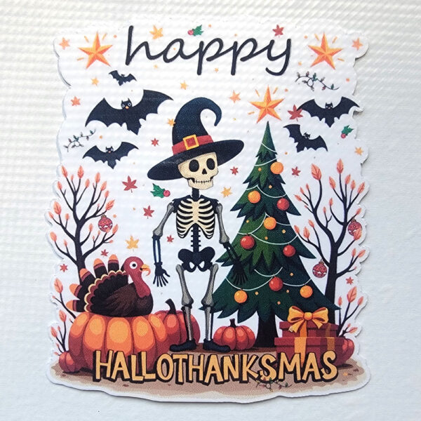 A vinyl sticker with a skeleton in a witch hat, a turkey, and a decorated Christmas tree with "Happy HalloThanksMas" text.